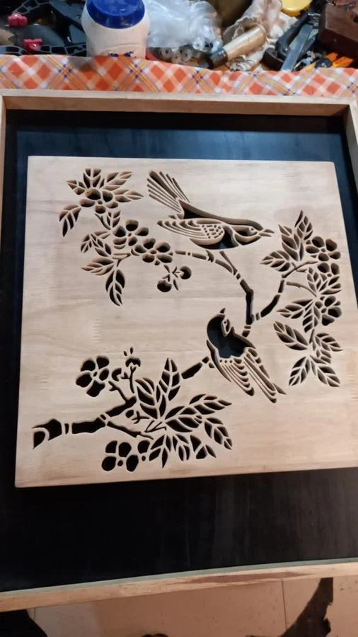 Birds and foliage hand-cut in wood, described by the artist as a birds and jungle theme