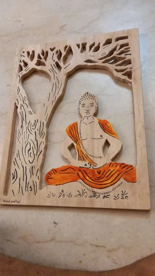 Buddha seated beneath a tree, cut as a layered relief panel