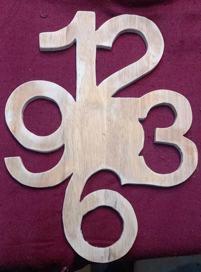 Free-standing cut wooden numerals for a wall clock
