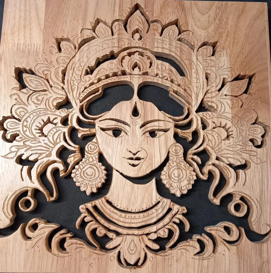 Layered devotional panel of a goddess set in an ornamental surround