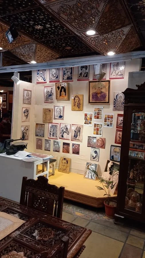 A room hung with framed scroll saw panels for display