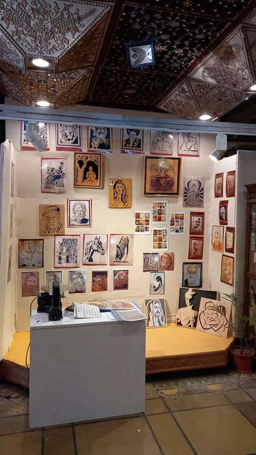 Display wall of framed wood portraits and animal panels