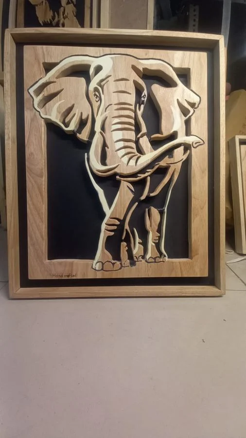 Elephant cut as a layered relief panel in a wooden frame