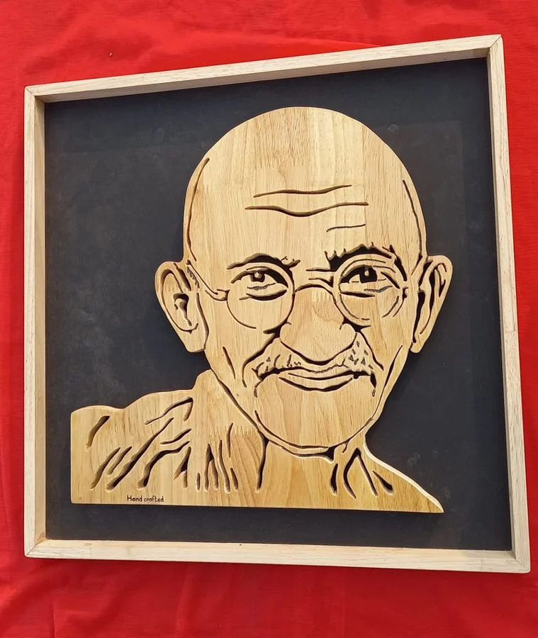 Mahatma Gandhi portrait hand-cut in solid wood, framed and mounted on a black backing