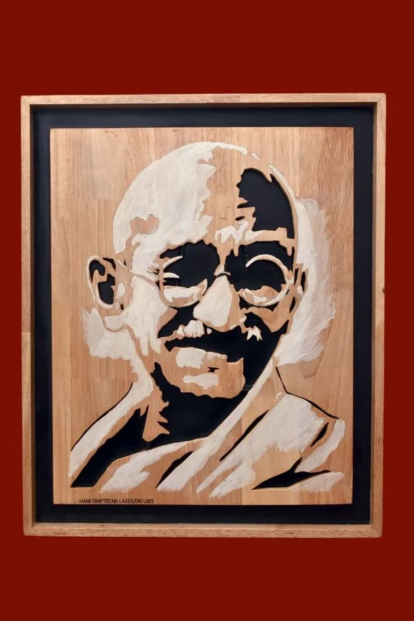 Gandhi portrait cut in rubber wood, showing the grain of the panel