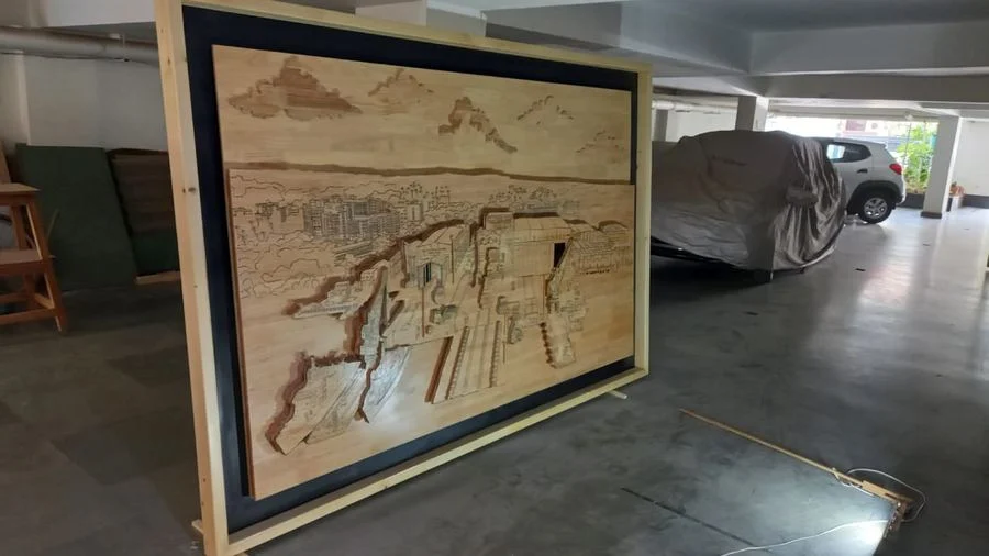 The Goa Shipyard mural in the workshop, with a car alongside showing its scale