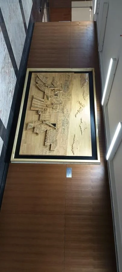 The mural installed and lit in a wood-panelled interior