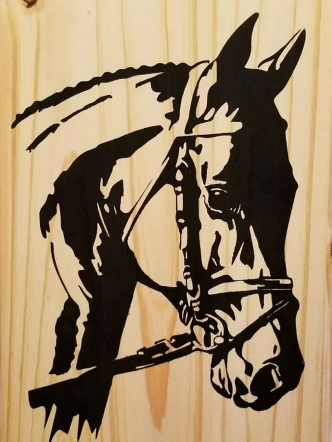 Horse in harness, hand-cut and painted black over wood