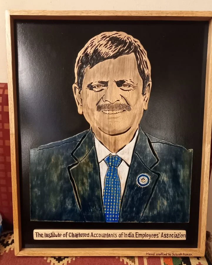 Framed portrait with a plaque reading The Institute of Chartered Accountants of India Employees Association