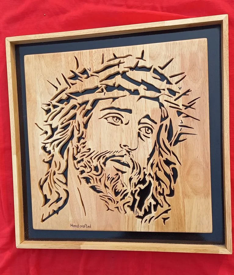 Christ crowned with thorns in a pale wood frame on a red ground
