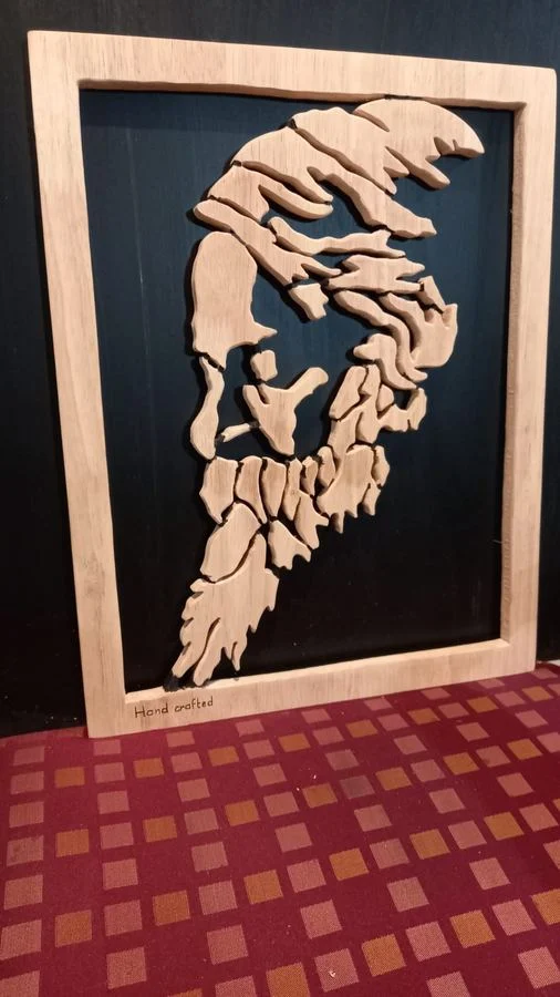 Layered relief panel cut in wood over a black backing