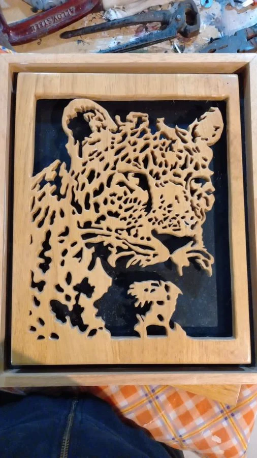 Leopard panel cut in wood and set in a shadow-box frame