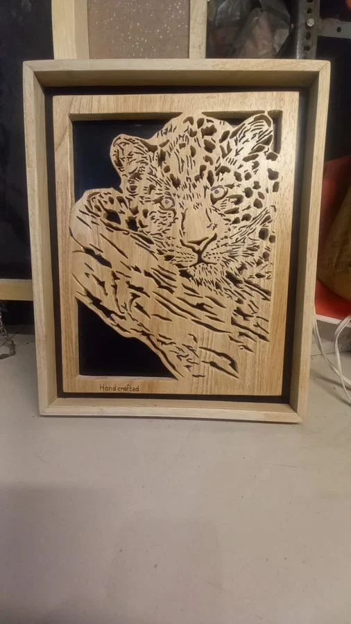 Framed leopard panel in scroll-sawn wood