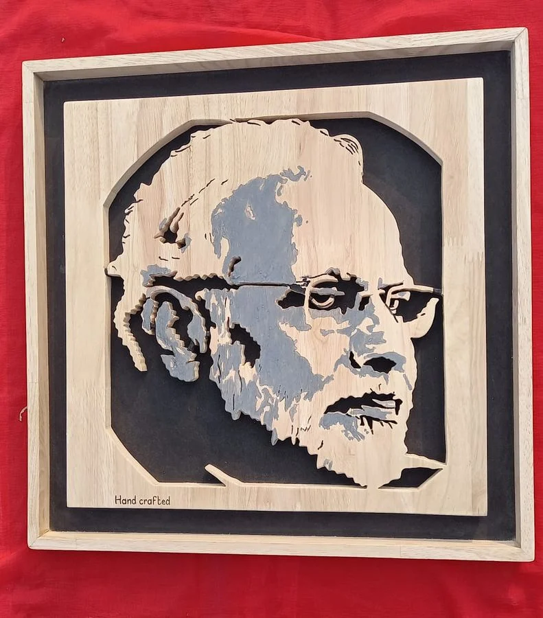 Hand-painted wood portrait mounted on a black backing