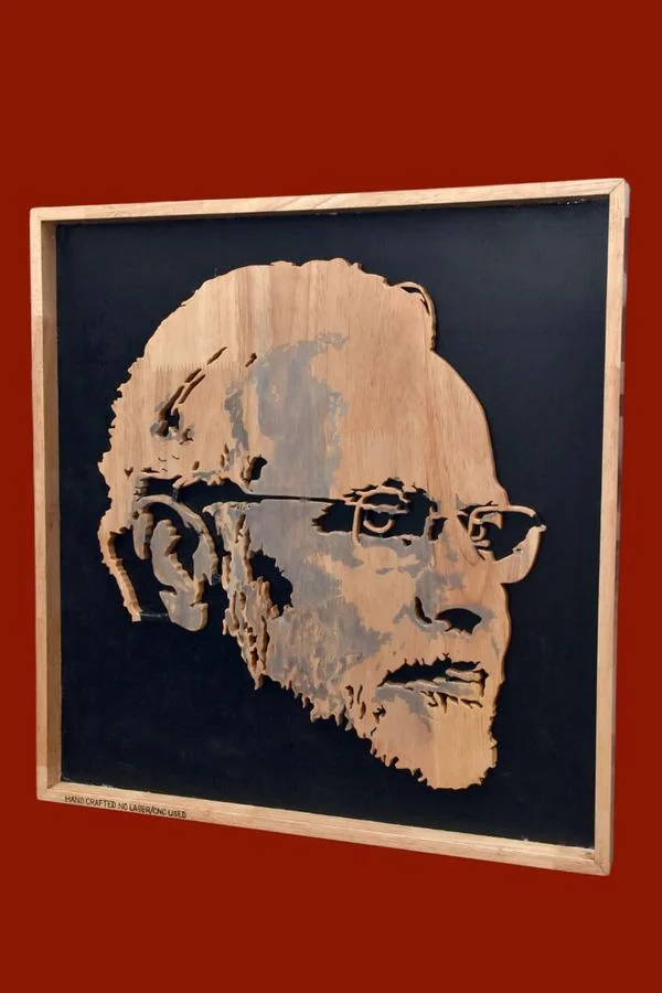 Hand-coloured wood portrait photographed against a red ground