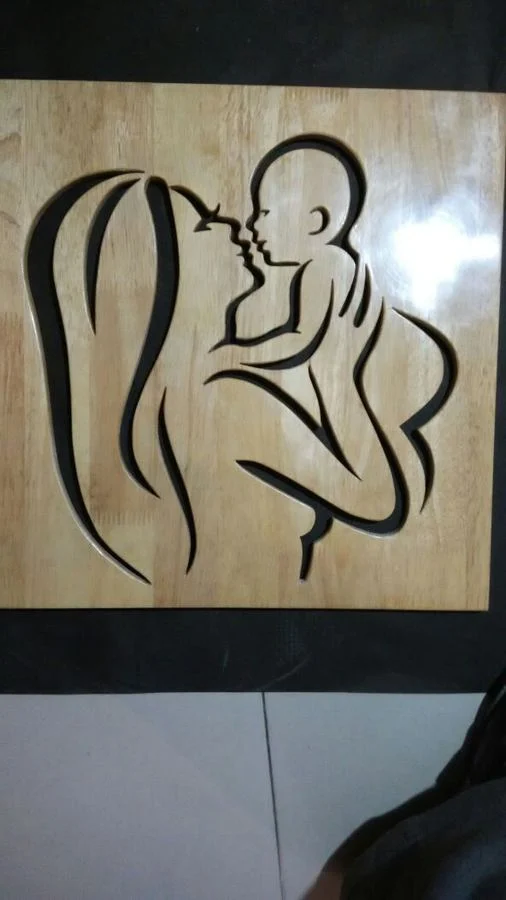 Line study of a mother and child cut in solid wood