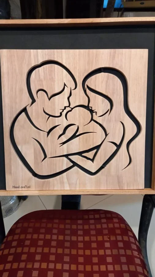 Mother and child line panel in a dark shadow-box frame