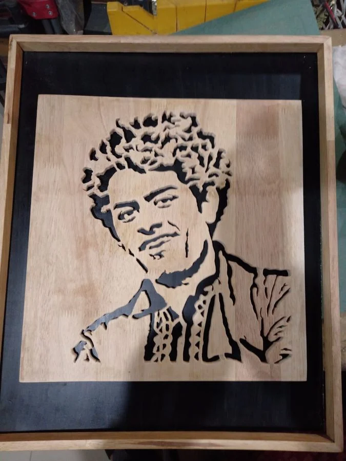 Portrait of a young man cut in wood and set in a deep frame