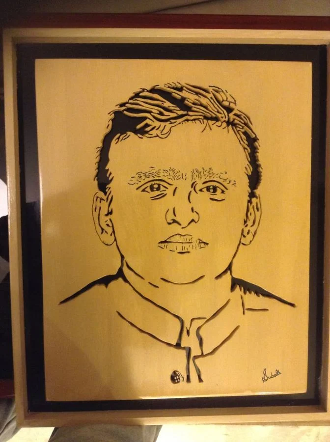Framed portrait signed by the artist, finished in a golden tone