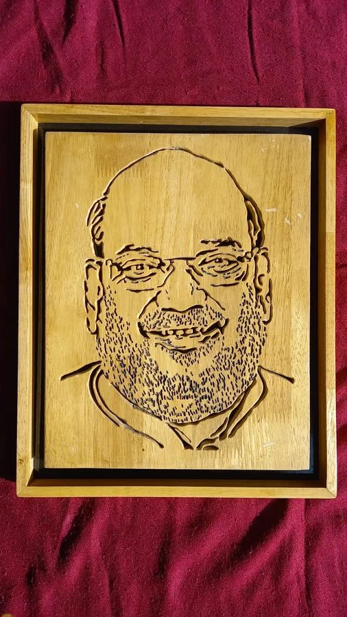 Framed wood portrait finished in a golden tone