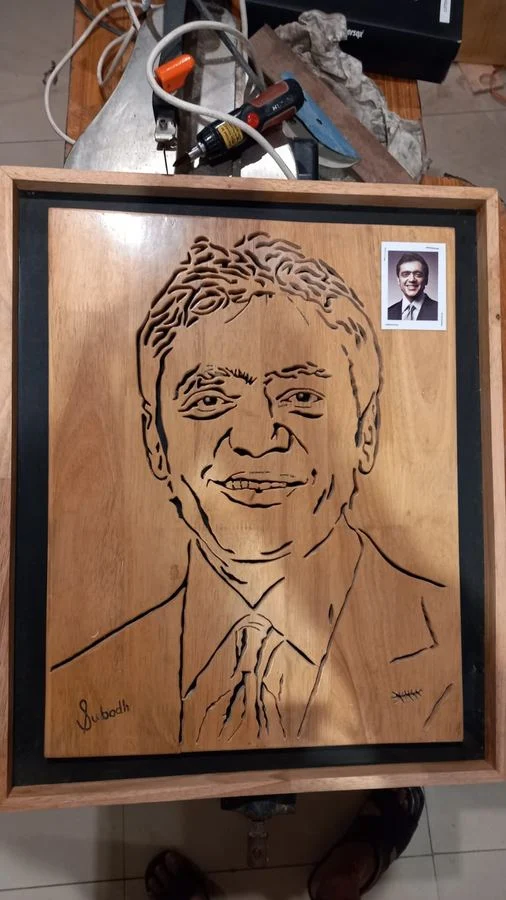 Portrait hand-cut in wood, photographed in the workshop