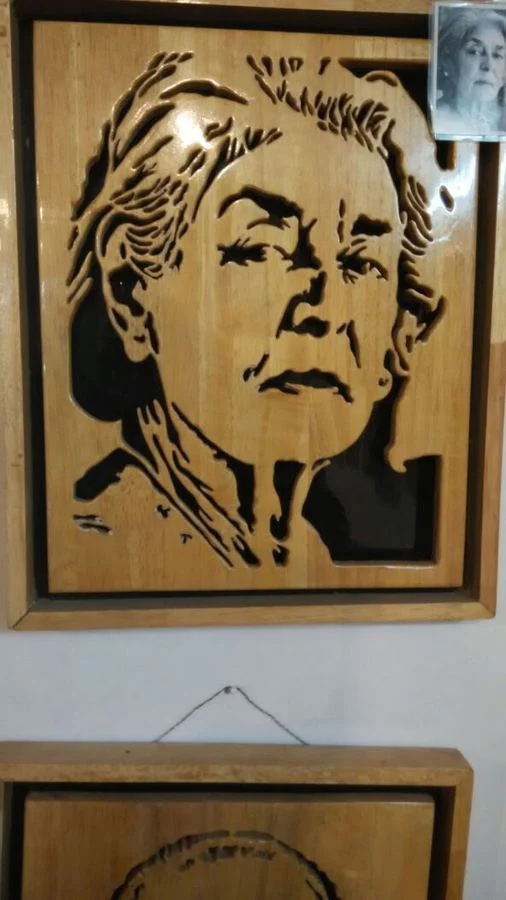 Portrait of a woman cut in wood over a black backing