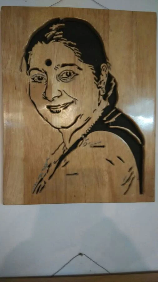 Portrait of a woman hand-cut on a single wood panel
