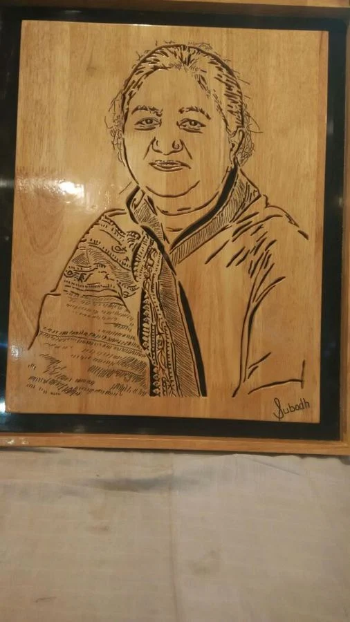 Portrait of a woman in a shawl, cut in pale wood