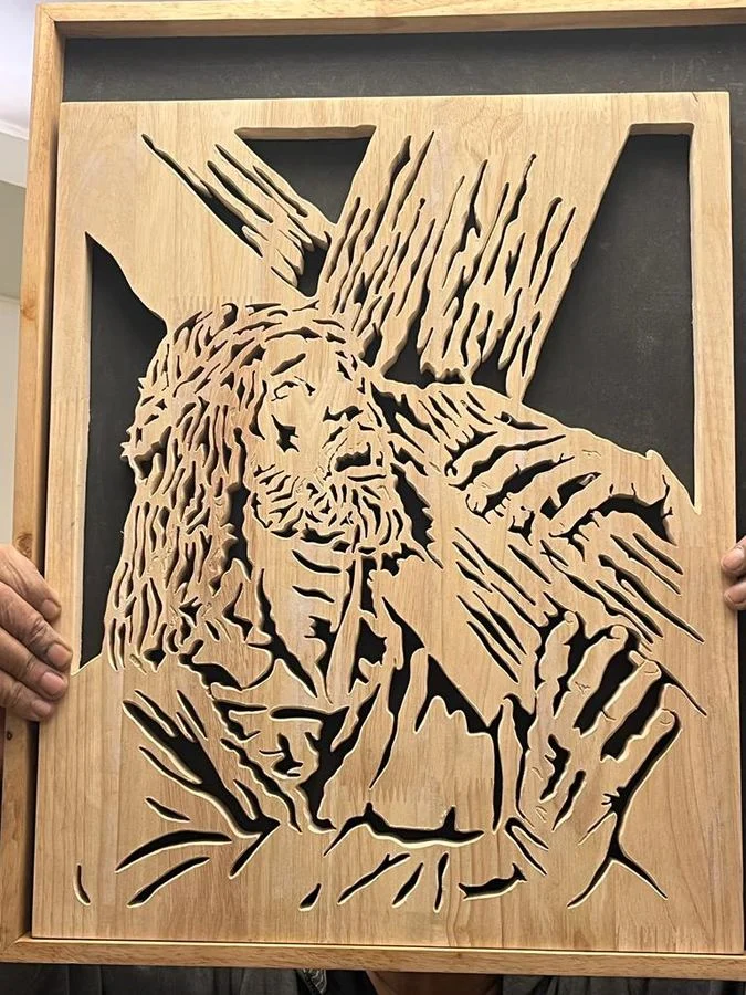 A large panel held up mid-way through cutting