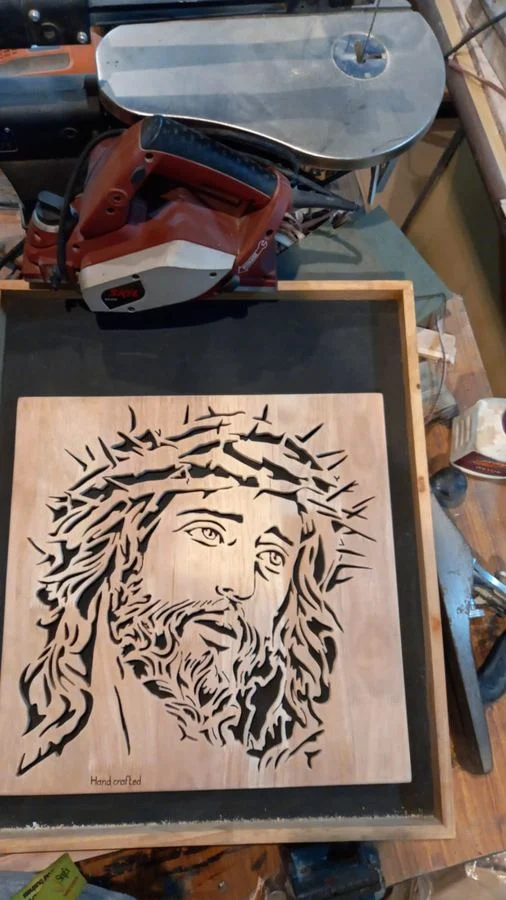 Cutting a portrait panel at the scroll saw