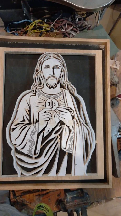 A devotional panel clamped in its frame in the workshop