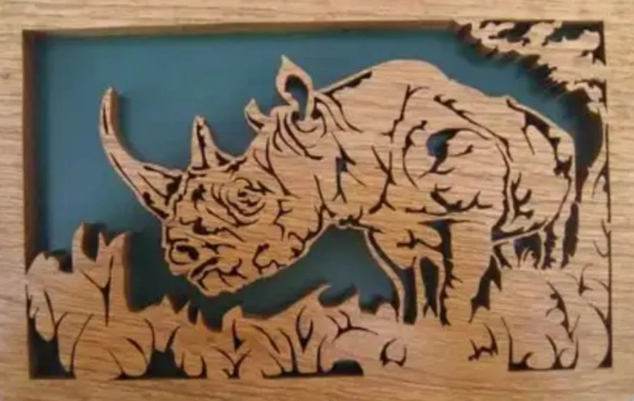 Rhinoceros in a landscape, cut as a layered wood panel