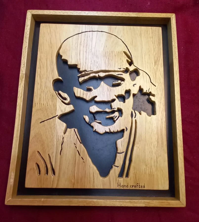 Sai Baba portrait hand-cut in wood, marked Handcrafted