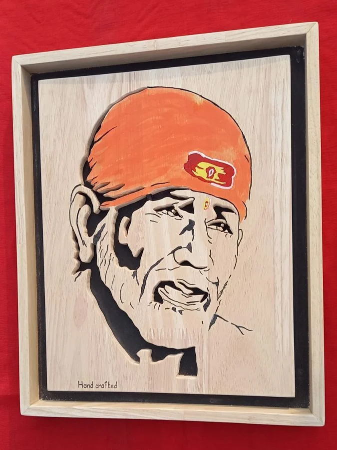Hand-coloured Sai Baba portrait framed in pale wood