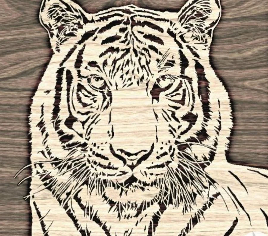 Close study of a tiger's face cut in solid wood