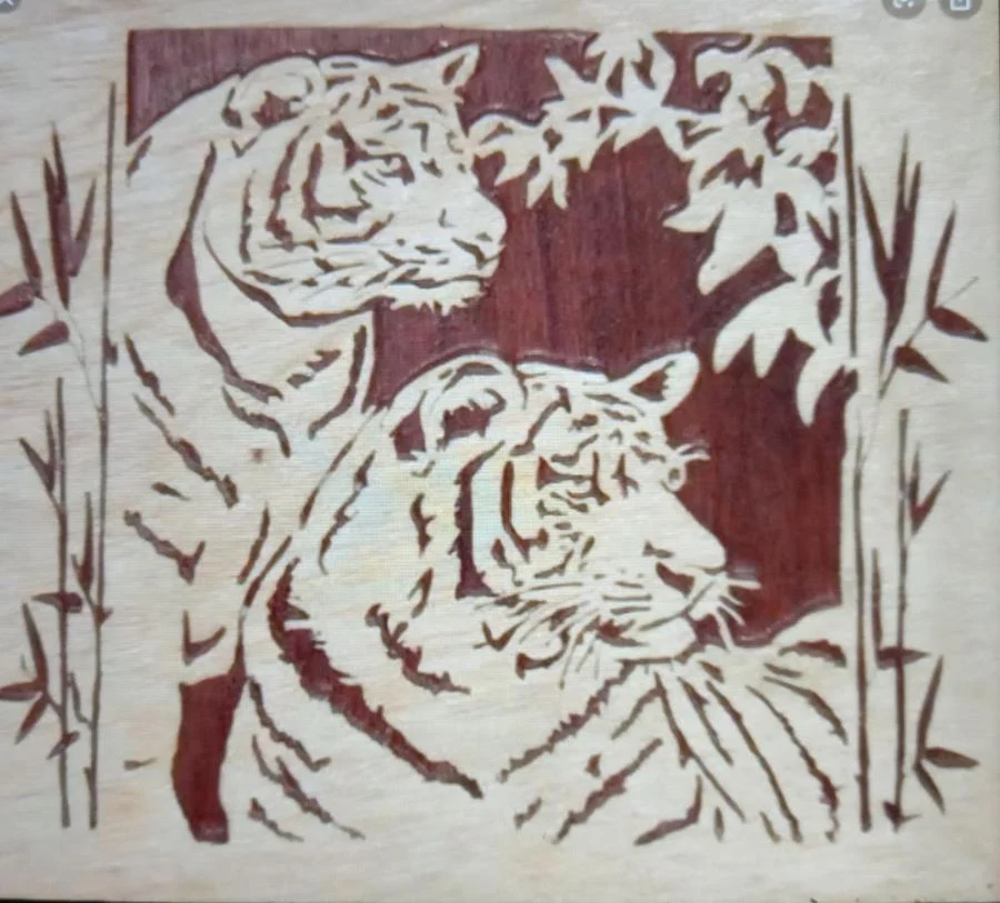 Two tigers among bamboo cut on a single wood panel