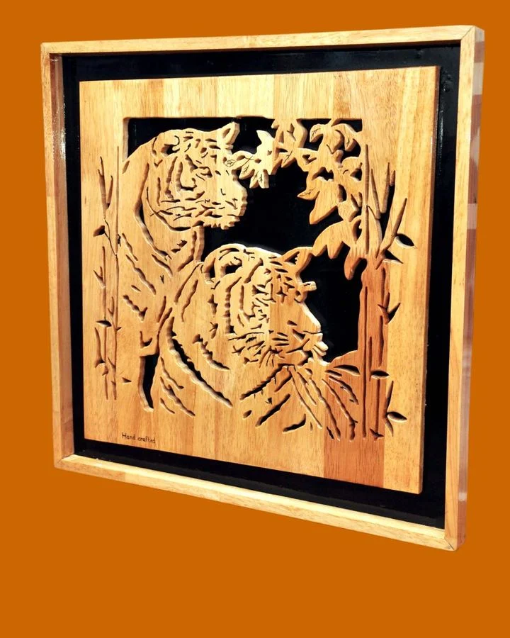 Framed panel of tigers among bamboo, shown at an angle